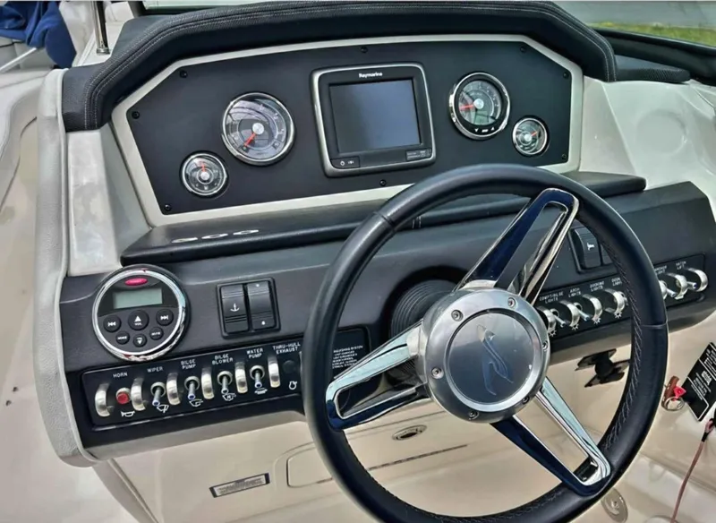 Slide: The Image of 2015 Sea Ray 300 SLX dashboard with steering wheel and control panel. - 22