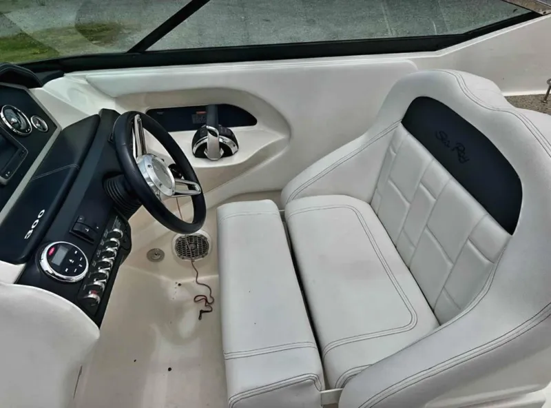 Slide: The Image of 2015 Sea Ray 300 SLX cockpit with white leather seating and modern controls. - 23