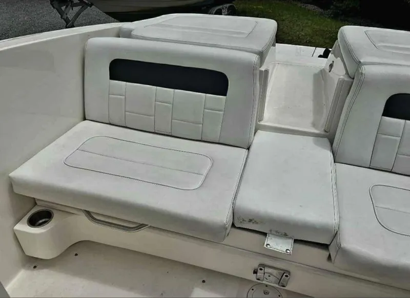 Slide: The Image of 2015 Sea Ray 300 SLX boat interior with white cushioned seating. - 26
