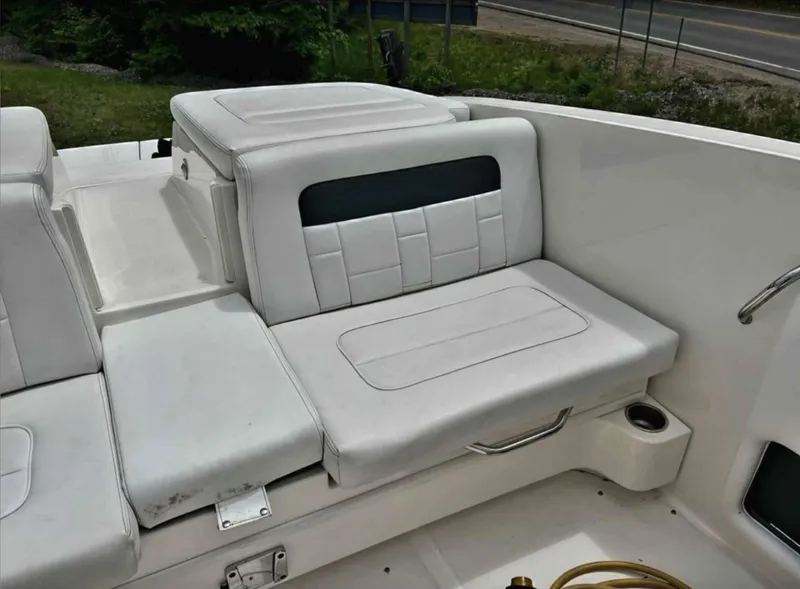 Slide: The Image of 2015 Sea Ray 300 SLX boat interior with white seating and cup holder. - 27