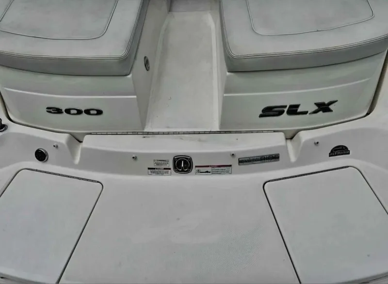 Slide: The Image of 2015 Sea Ray 300 SLX boat deck with seating and model branding. - 30