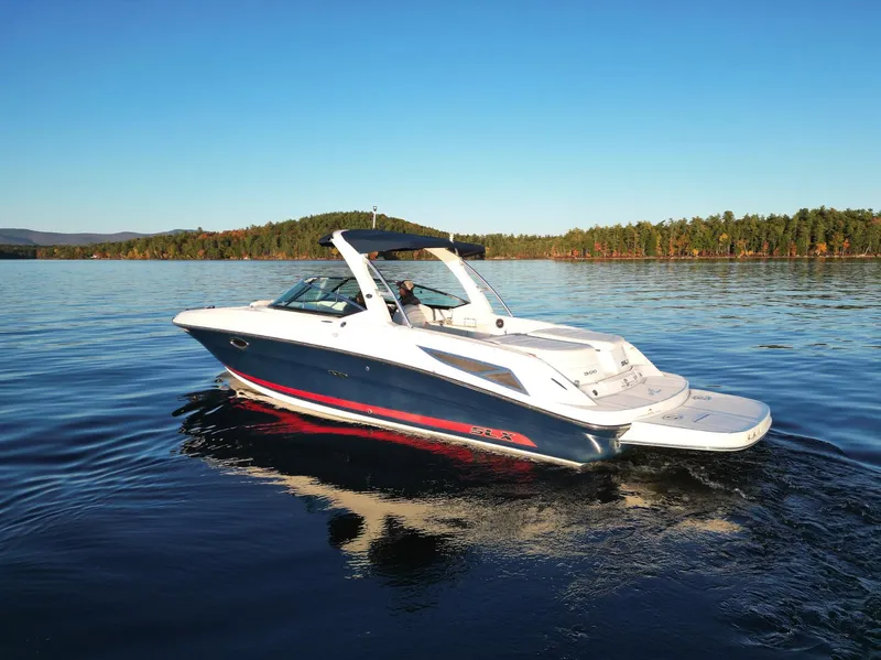 Slide: The Image of 2015 Sea Ray 300 SLX boat cruising on a calm lake. - 4