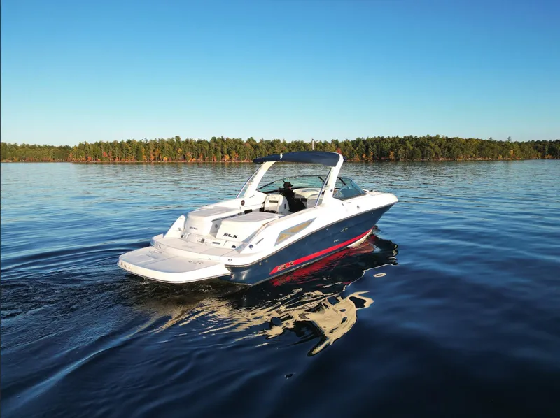Slide: The Image of 2015 Sea Ray 300 SLX boat cruising on a serene lake. - 7