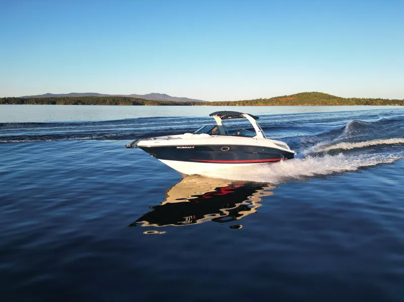 Slide: The Image of 2015 Sea Ray 300 SLX cruising on a serene lake at sunset. - 9