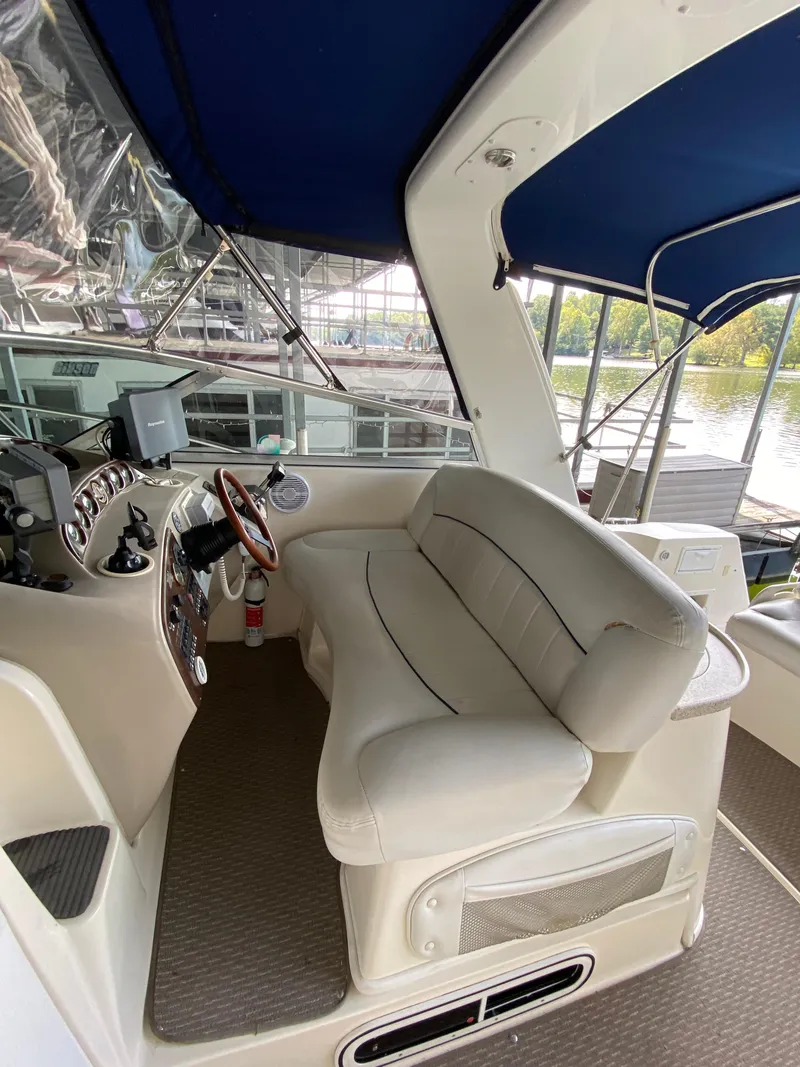 Slide: The Image of Interior of a 2000 Rinker 340 Fiesta Vee boat with helm and seating area. - 10