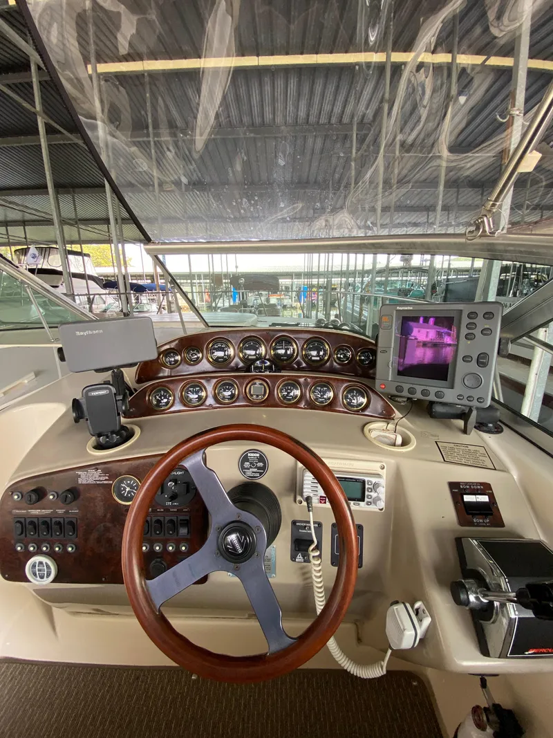 Slide: The Image of Helm of 2000 Rinker 340 Fiesta Vee with gauges and navigation equipment. - 13