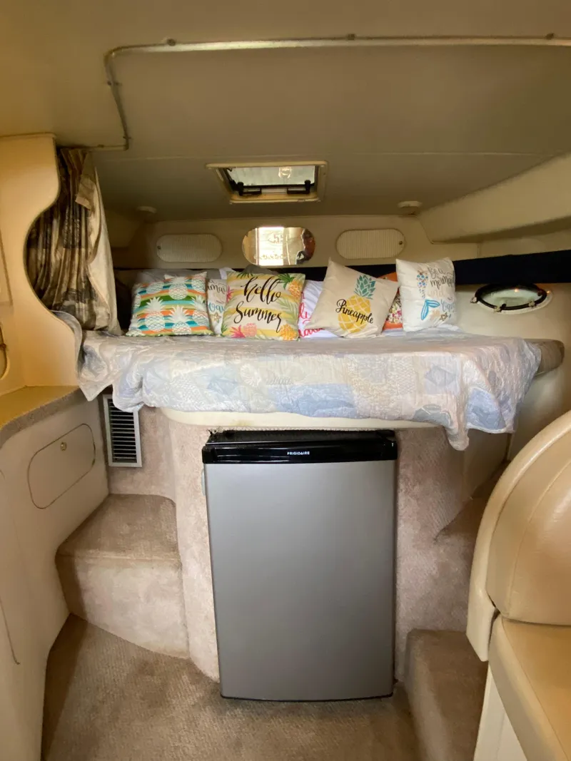 Slide: The Image of Interior of 2000 Rinker 340 Fiesta Vee with cozy bed and compact fridge. - 18