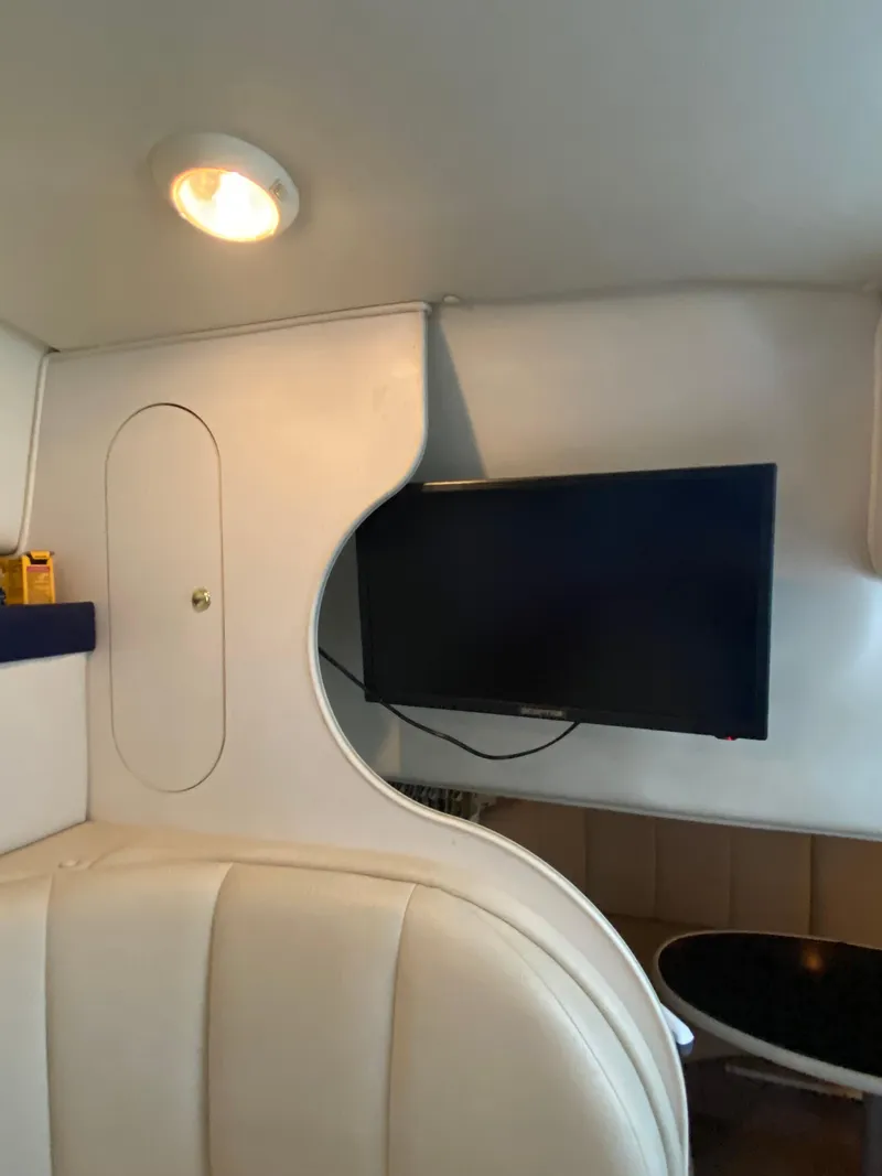Slide: The Image of Interior of 2000 Rinker 340 Fiesta Vee with TV and seating area. - 24