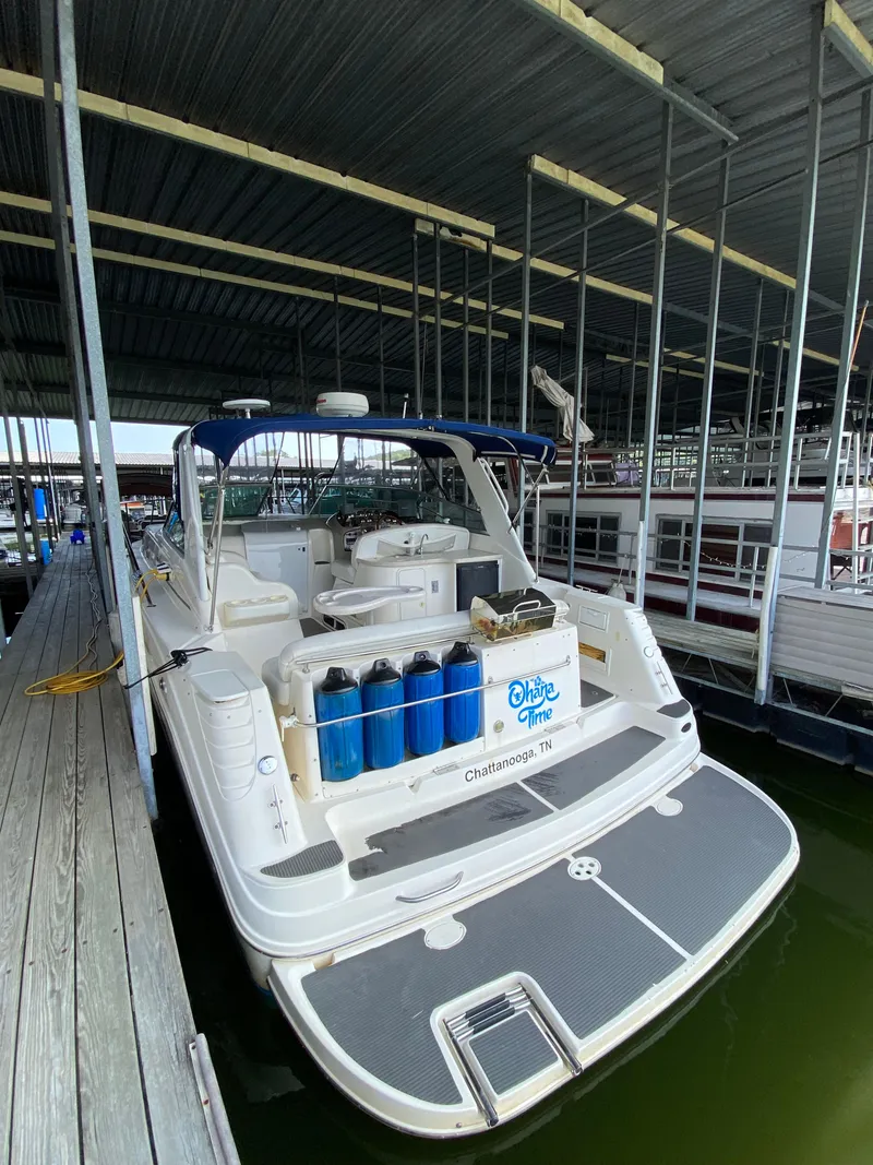 Slide: The Image of 2000 Rinker 340 Fiesta Vee boat docked in a covered marina. - 4