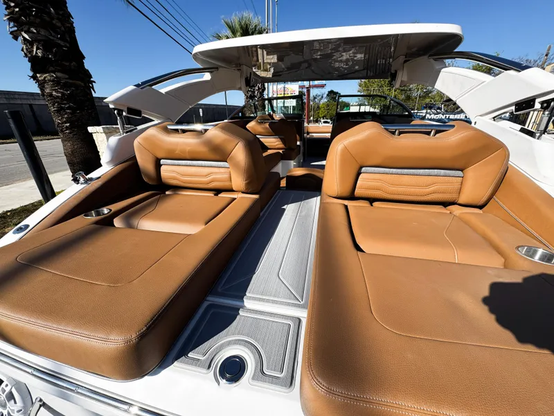 Slide: The Image of 2025 Regal LS6 boat with luxurious tan leather seating and sleek design. - 12