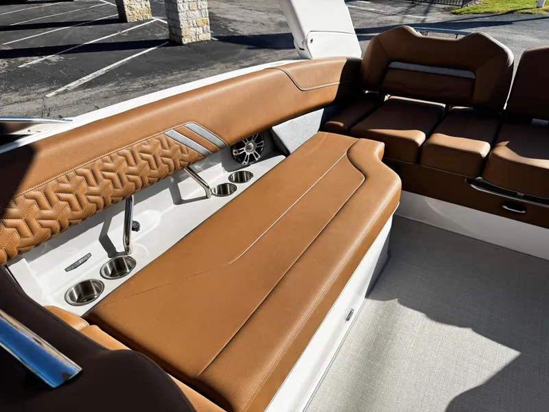 Slide: The Image of Luxurious 2025 Regal LS6 boat interior with brown leather seating and cup holders. - 17