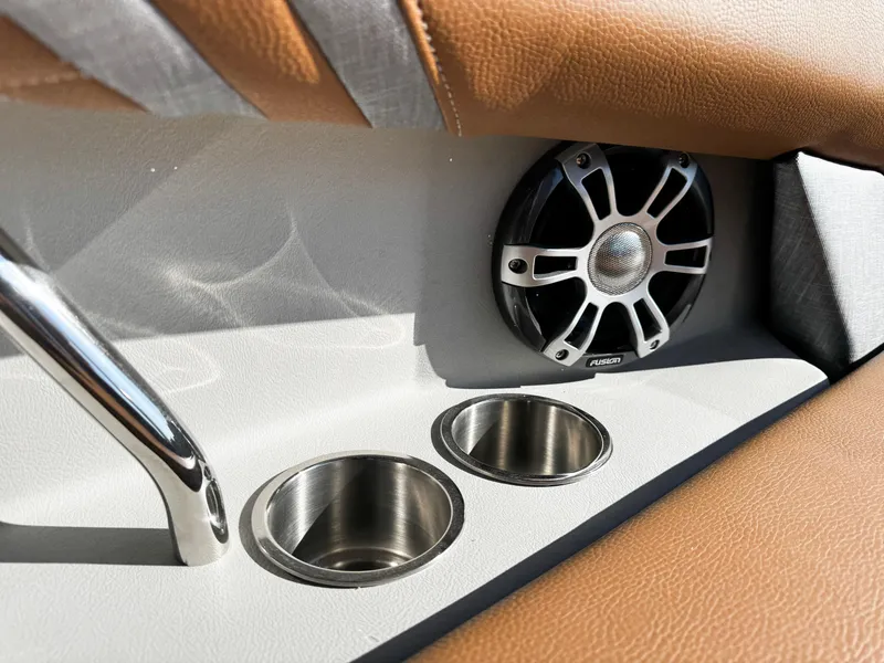 Slide: The Image of 2025 Regal LS6 interior with speaker, cup holders, and brown leather accents. - 23