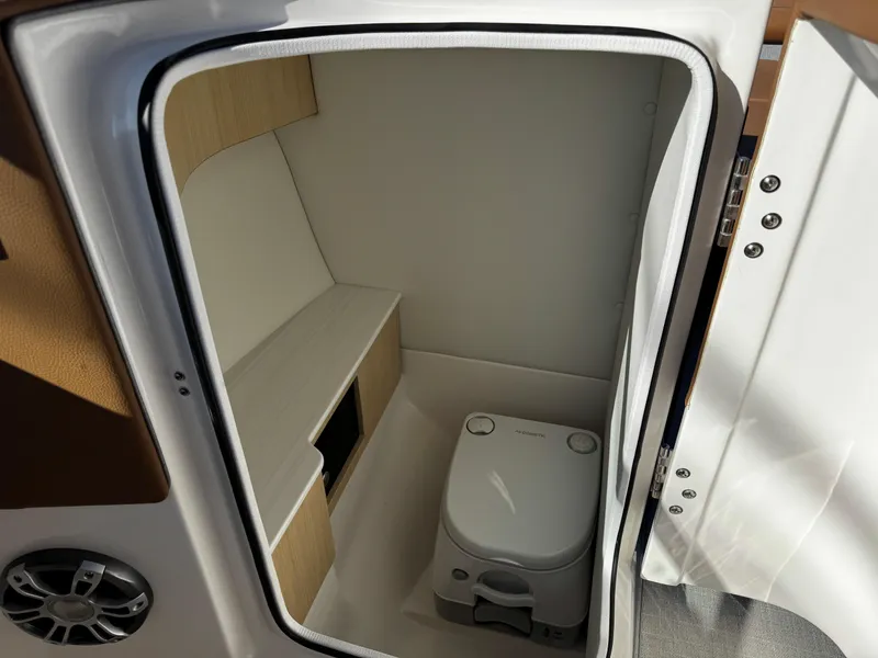 Slide: The Image of 2025 Regal LS6 boat interior with compact toilet and storage space. - 30