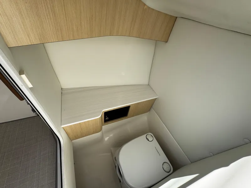 Slide: The Image of Compact bathroom in 2025 Regal LS6 boat with modern design and portable toilet. - 31
