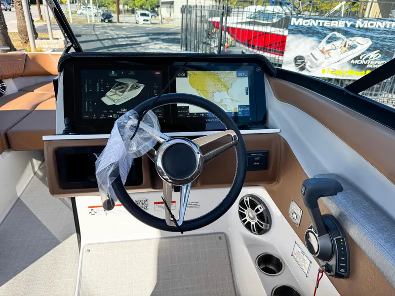 Slide: The Image of 2025 Regal LS6 boat dashboard with steering wheel and navigation screens. - 35