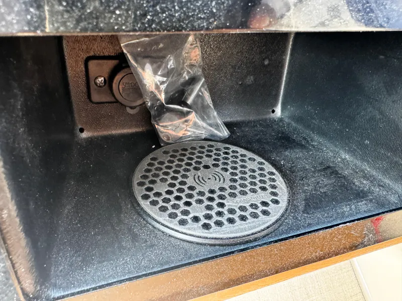 Slide: The Image of 2025 Regal LS6 storage compartment with wireless charging pad and USB port. - 38