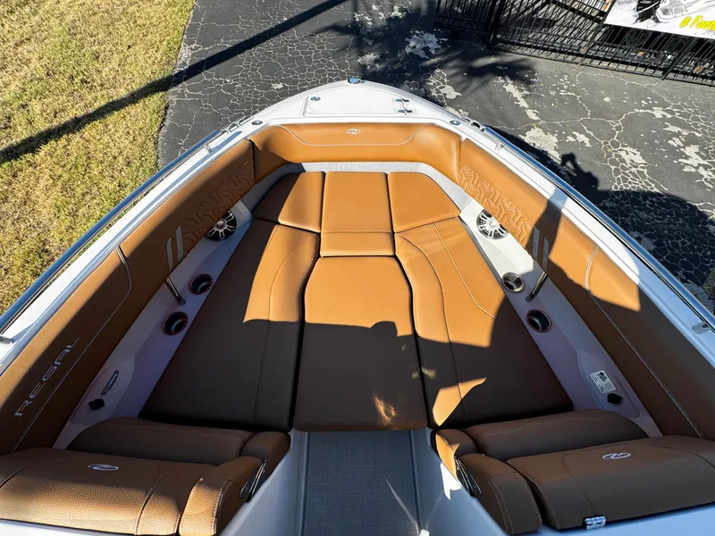 Slide: The Image of 2025 Regal LS6 boat interior with tan leather seating and sleek design. - 48