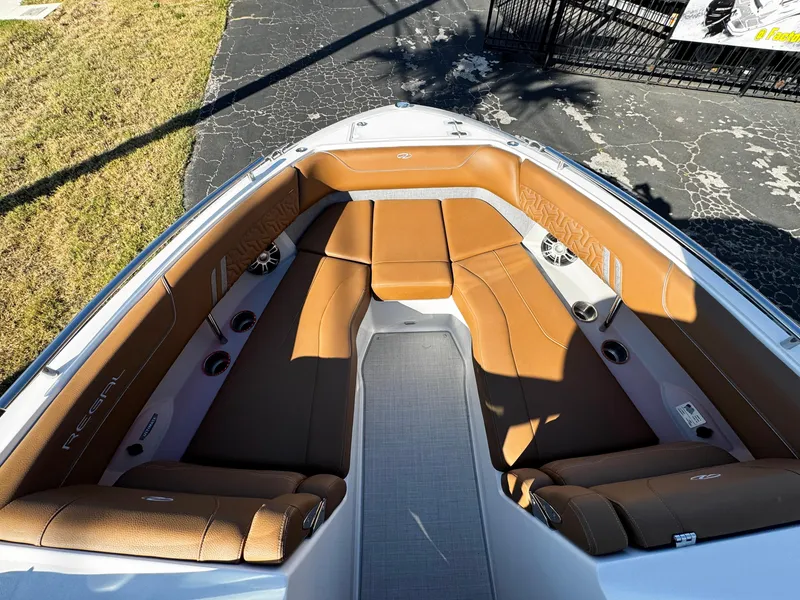 Slide: The Image of 2025 Regal LS6 boat interior with brown leather seating and modern design. - 49
