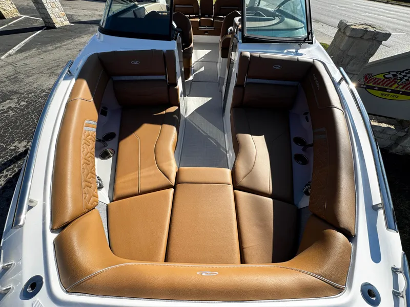 Slide: The Image of 2025 Regal LS6 boat interior with tan leather seating and open bow design. - 50