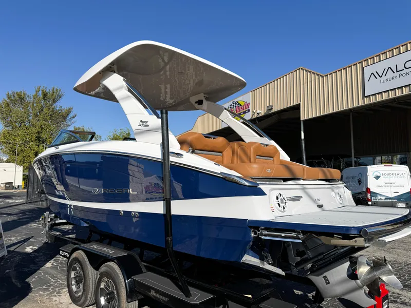 Slide: The Image of 2025 Regal LS6 boat with blue and white exterior on a trailer. - 6