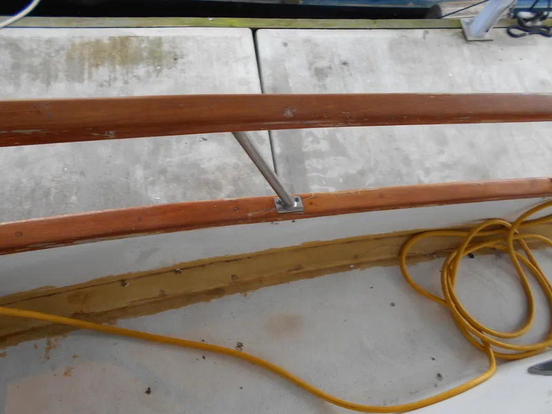 Slide: The Image of 1977 Davis 42' boat deck with wooden railing and coiled yellow cable. - 11