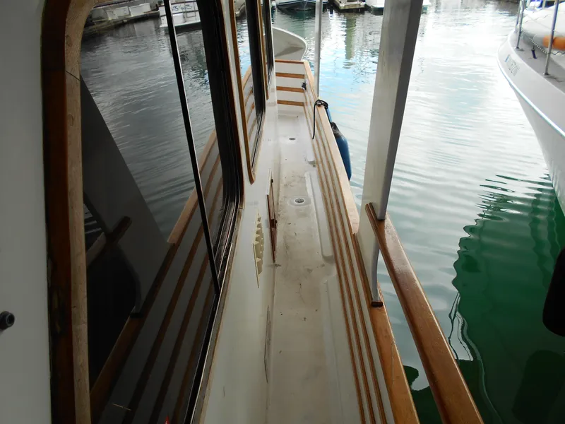 Slide: The Image of Side deck view of a 1977 Davis 42' boat docked at a marina. - 14