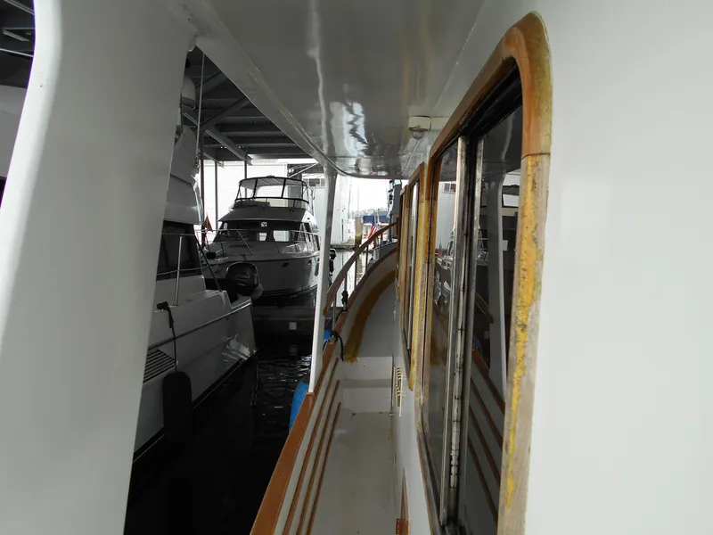 Slide: The Image of 1977 Davis 42' yacht docked in marina, side view with other boats nearby. - 15