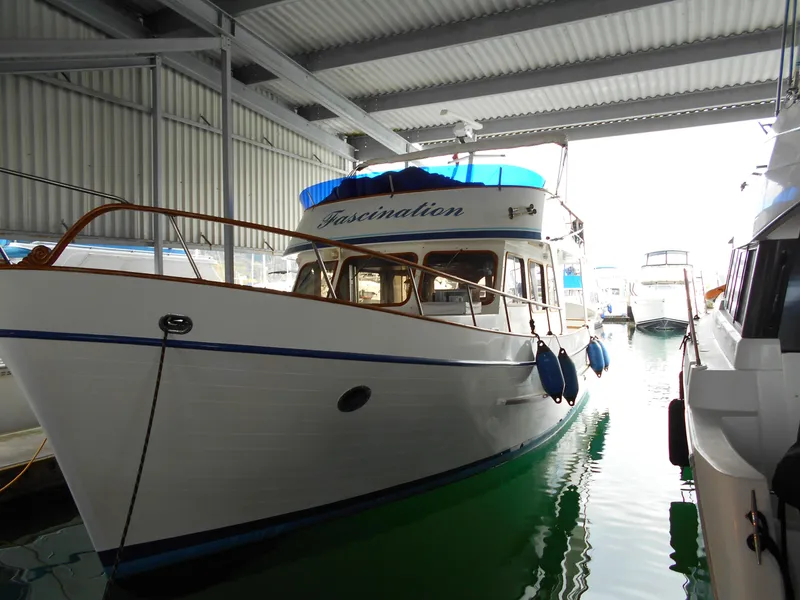 Slide: The Image of 1977 Davis 42' boat docked in a covered marina. - 2