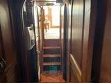 Slide: The Image of Interior hallway of a 1977 Davis 42' boat with wooden paneling and stairs. - 27
