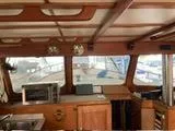 Slide: The Image of Interior of a 1977 Davis 42' boat with wooden cabinetry and nautical decor. - 30