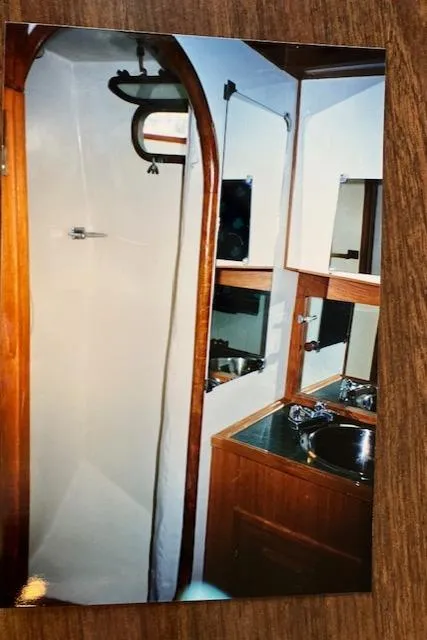 Slide: The Image of 1977 Davis 42' yacht bathroom with wood accents and stainless steel sink. - 33