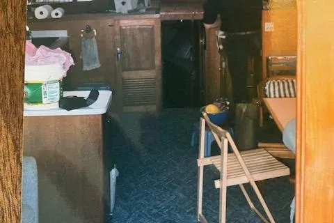 Slide: The Image of Interior of a 1977 Davis 42' boat with wooden cabinetry and seating area. - 34