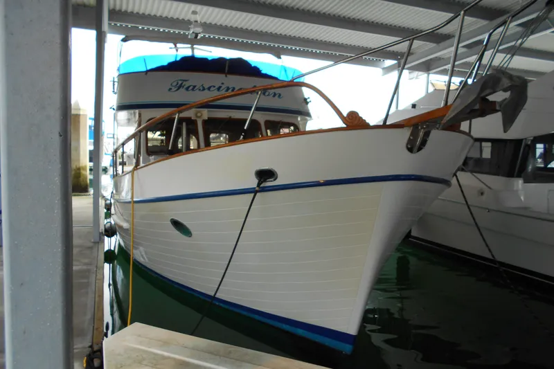 Slide: The Image of 1977 Davis 42' boat docked under a covered marina. - 37