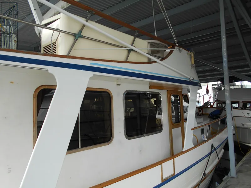 Slide: The Image of 1977 Davis 42' boat docked under a covered marina. - 7