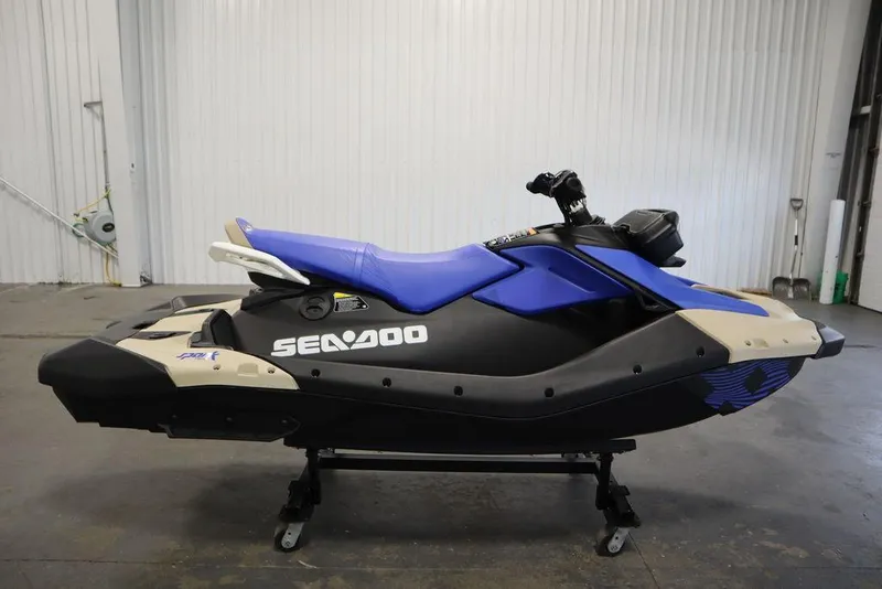 Slide: The Image of 2025 Sea-Doo Spark Trixx jet ski with blue seat in a garage setting. - 10