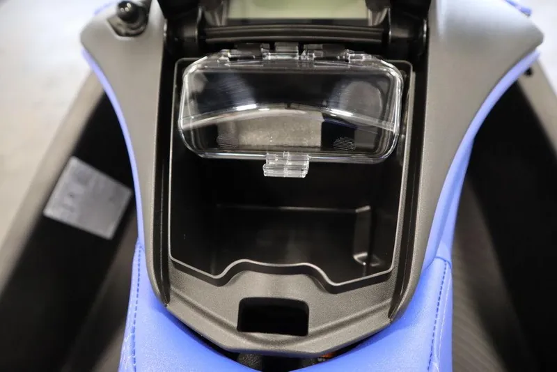 Slide: The Image of 2025 Sea-Doo Spark Trixx storage compartment with clear cover, showcasing interior design. - 13