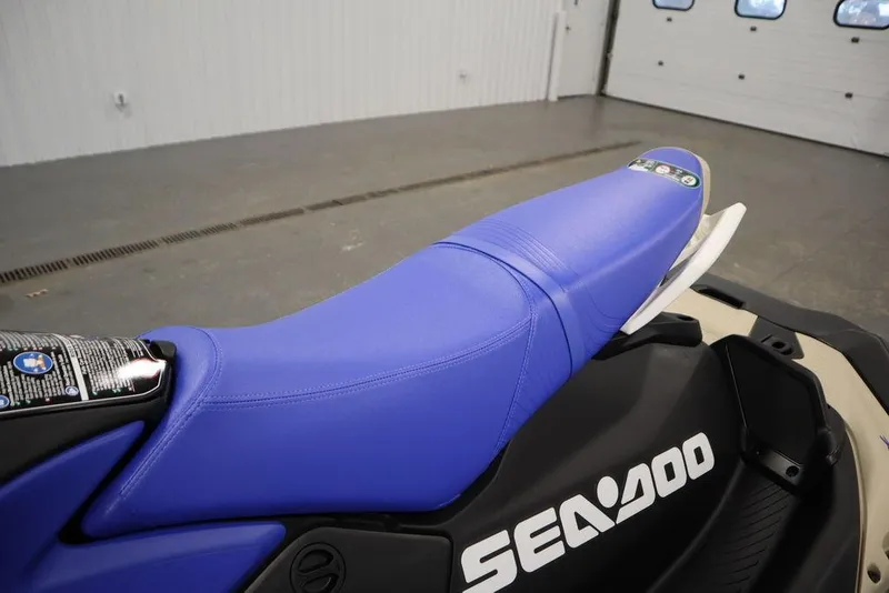 Slide: The Image of 2025 Sea-Doo Spark Trixx jet ski with blue seat in a garage setting. - 14