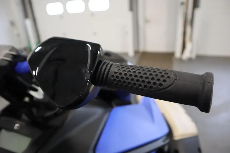 Slide: The Image of Handlebar of 2025 Sea-Doo Spark Trixx with textured grip and mirror. - 2