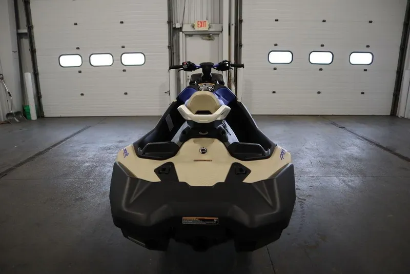 Slide: The Image of 2025 Sea-Doo Spark Trixx jet ski in a garage, rear view. - 8