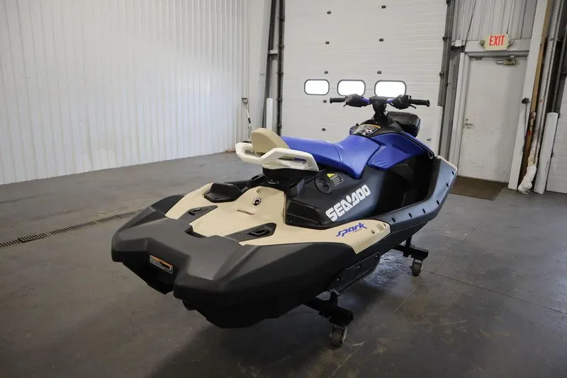 Slide: The Image of 2025 Sea-Doo Spark Trixx jet ski in a garage, featuring blue and beige design. - 9