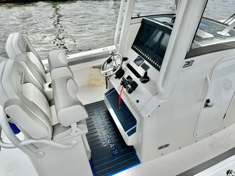 Slide: The Image of 2023 Regulator 28 boat cockpit with dual seats and modern control panel. - 14
