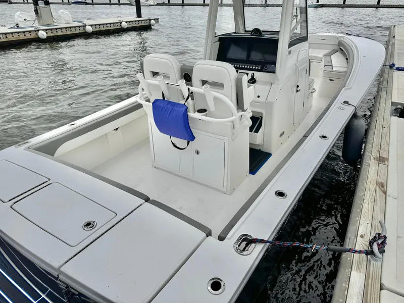 Slide: The Image of 2023 Regulator 28 boat docked, featuring dual seats and a sleek design. - 16