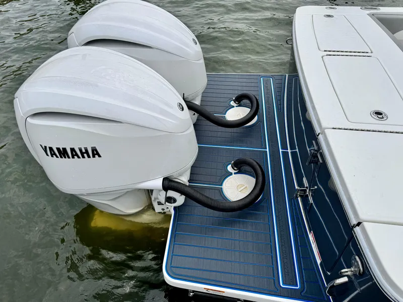 Slide: The Image of 2023 Regulator 28 boat with twin Yamaha outboard engines on water. - 17