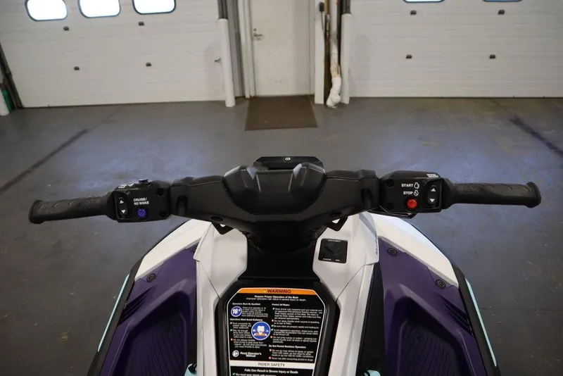 Slide: The Image of 2025 Yamaha WaveRunner JetBlaster LTD side mirror in a garage setting. - 23