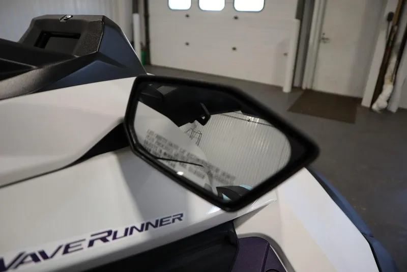 Slide: The Image of 2025 Yamaha WaveRunner JetBlaster LTD side mirror in a garage setting. - 24