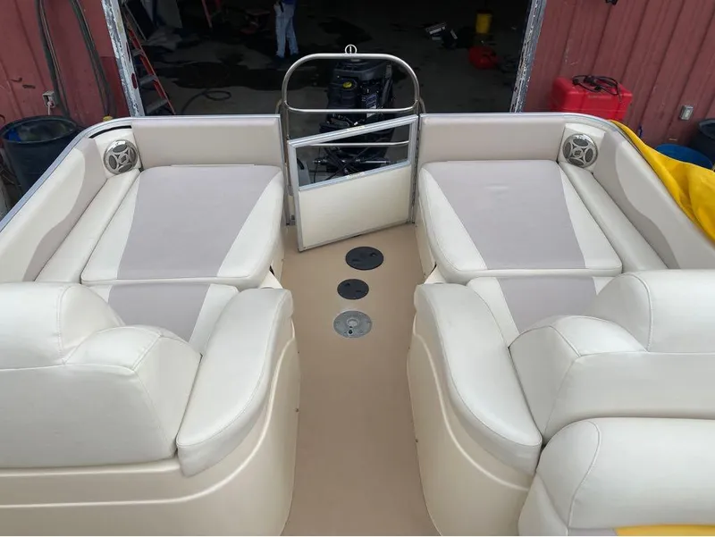 Slide: The Image of Interior of 2012 Godfrey AP 240 pontoon boat with beige seating and speakers. - 13