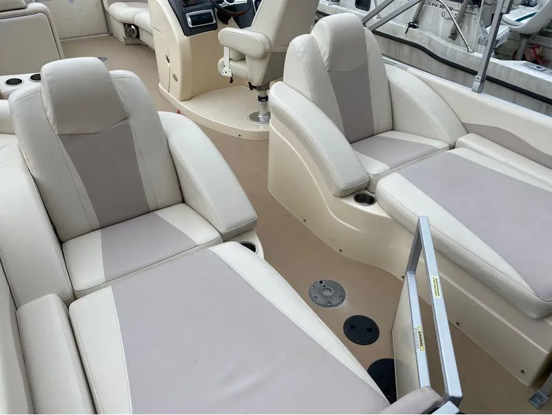 Slide: The Image of Luxurious seating on 2012 Godfrey AP 240 boat, featuring beige and cream upholstery. - 9