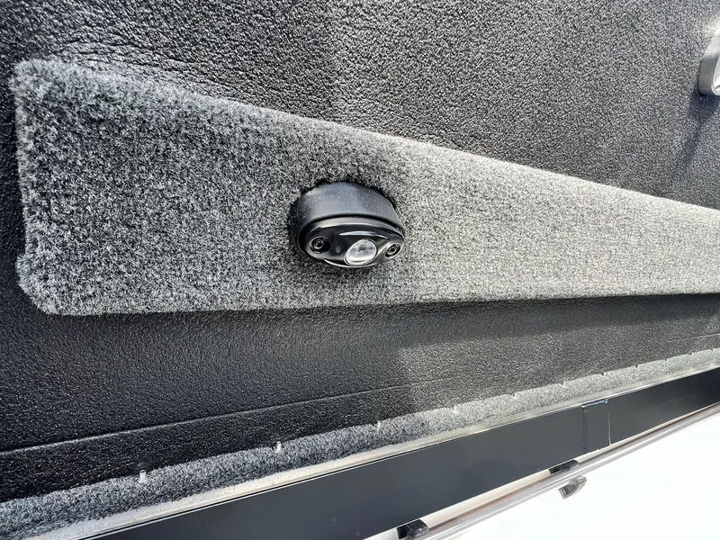 Slide: The Image of 2025 Skeeter FXR21 LE boat interior with textured panel and mounted light. - 10