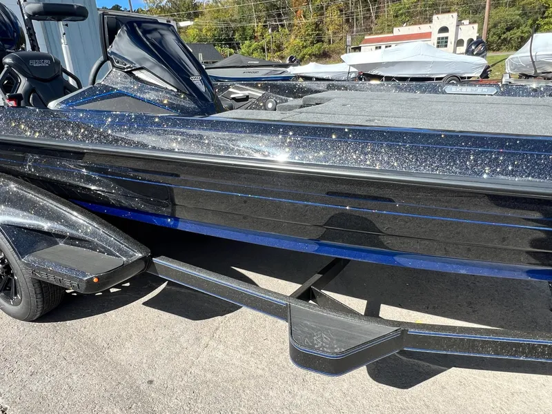 Slide: The Image of 2025 Skeeter FXR21 LE boat with sparkling black finish on a trailer. - 15