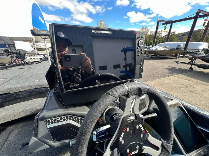 Slide: The Image of 2025 Skeeter FXR21 LE boat dashboard with Humminbird Helix 12 display. - 19